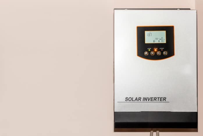 Onduleur solaire posé sur le mur d'une maison